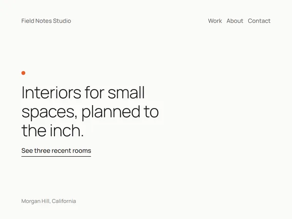 Specimen: an interior design page that is almost empty, with one light headline, an orange dot and one link.
